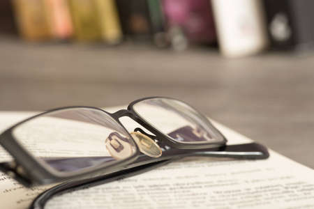 A book and reading glassesの写真素材