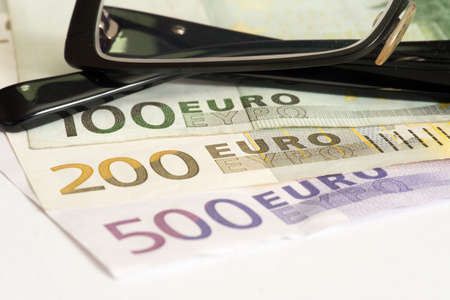 A pair of glasses and euro billsの写真素材
