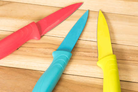 Colorful knives on a kitchen table