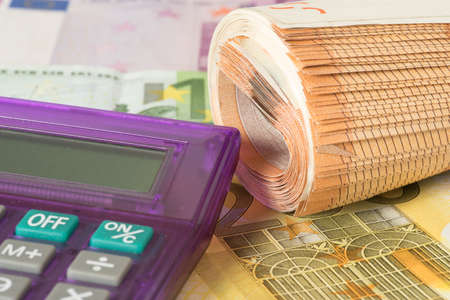 A calculator and many euro bills