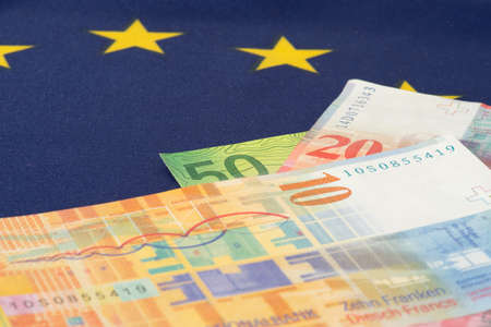 Flag of the European Union EU and Swiss Franc banknotesの写真素材
