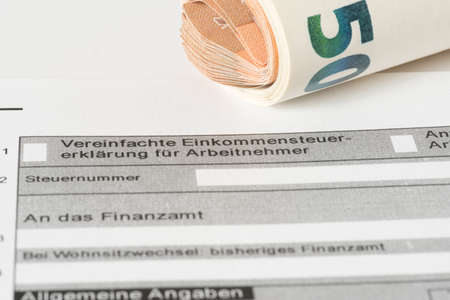 A form for a tax declaration and euro billsの写真素材