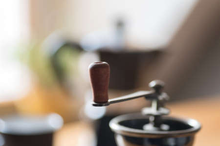 An espresso cooker, coffee grinder and a cupの写真素材