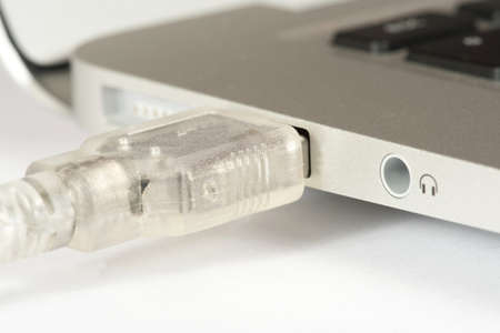 A laptop and a USB plug