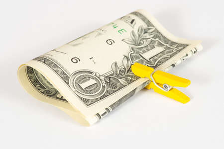 A dollar bill and a clothespinの写真素材