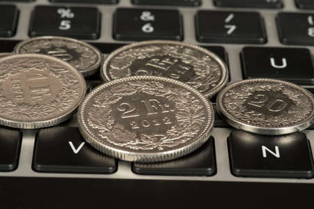 Coins Swiss franc and a computerの写真素材