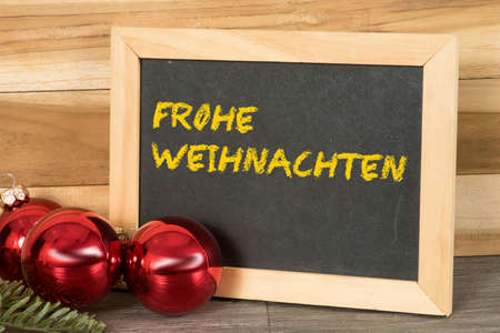 Christmas balls and a chalkboard with the text Merry Christmasの写真素材