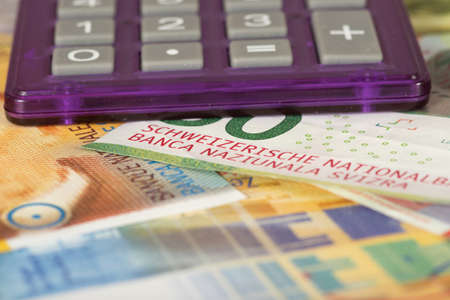 Banknotes Swiss Francs and a calculatorの写真素材