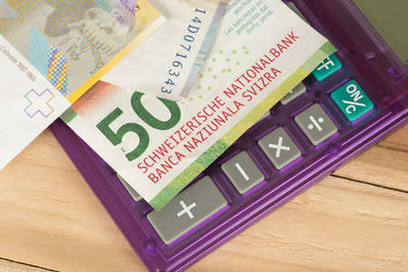 Banknotes Swiss Francs and a calculatorの写真素材