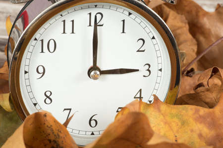 Leaves and a time change clock for winter time