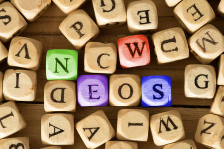 Many wooden letters and the word News