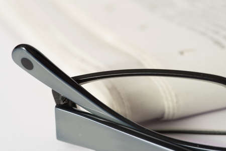 A pair of glasses and a newspaperの写真素材