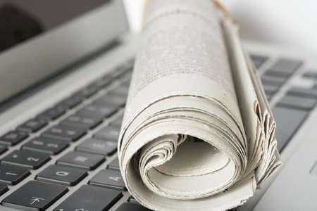 A newspaper and a computerの写真素材