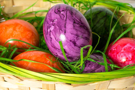 Colorful eggs at Easter and a basket