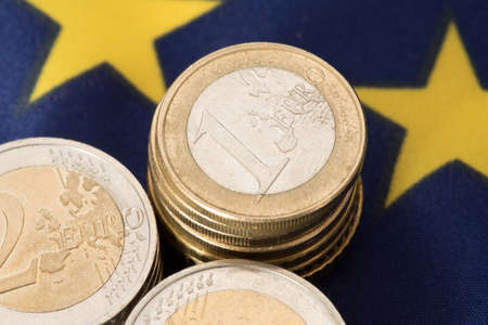Many Euro coins and the flag of the European Union EUの写真素材