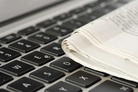 A newspaper and a computerの写真素材