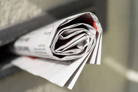 A newspaper in a mailboxの写真素材
