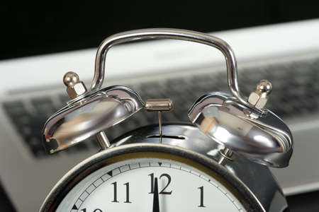 A laptop and an alarm clockの写真素材
