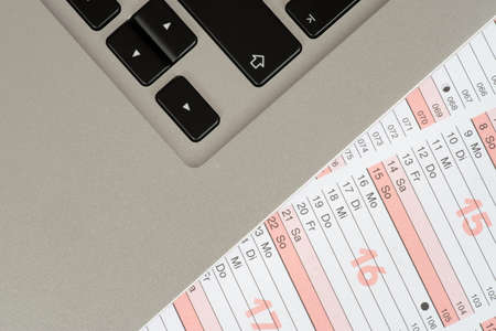 A calendar and a laptopの写真素材