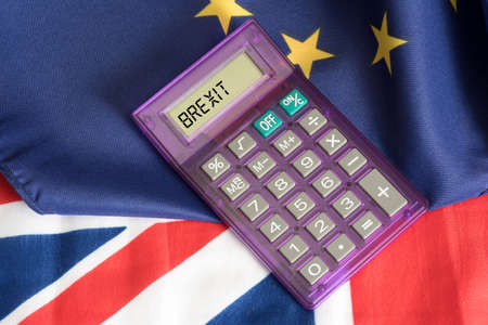 Flags of the EU and Britain and a calculator with the word Brexit
