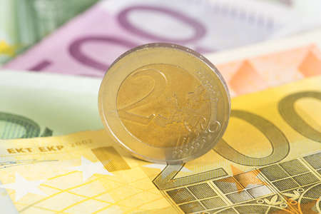 A 2 euro coin and many banknotes
