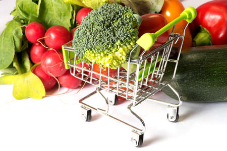 Various vegetables for a healthy nutrition and a shopping cartの写真素材
