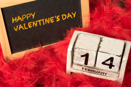 A Valentine's Day calendar and a chalk board with the slogan Happy Valentines Dayの写真素材