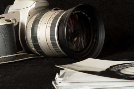 An old, analog camera and black and white photos