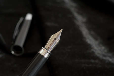 An elegant fountain pen on black backgroundの写真素材