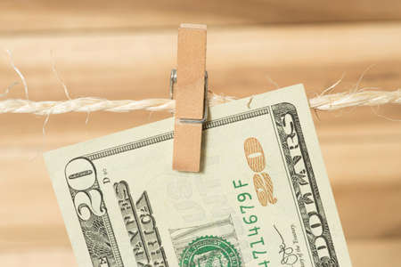 A $ 20 bill on a clothes line with a clothespinの写真素材