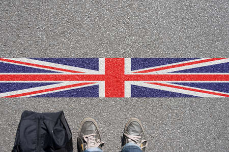 A man with the suitcase is on the border with Great Britain A man with the suitcase is on the border with Great Britain