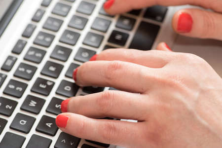 A woman works in the office on a laptop
