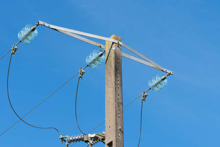 Electricity pylon and blue sky in the background