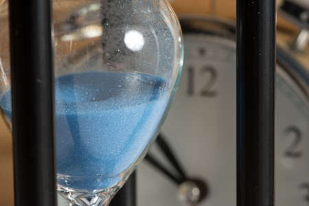 An hourglass and an alarm clock