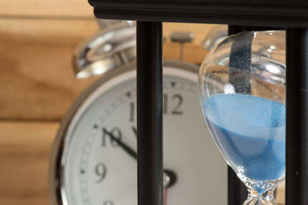 An hourglass and an alarm clock