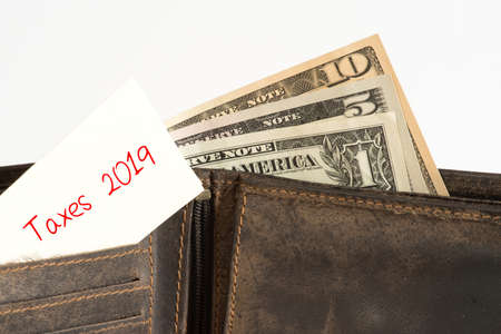 Dollar bills, wallet and taxes 2019 in America