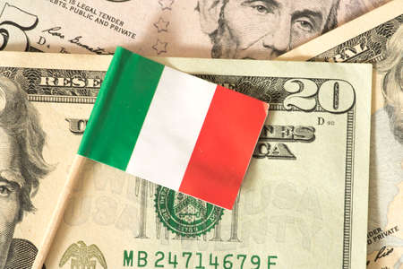 Flag of Italy and dollar bills in the backgroundの写真素材