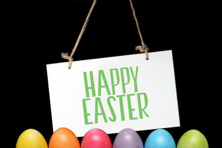 Easter eggs and a sign with the slogan Happy Easterの写真素材