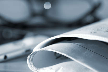 A newspaper, reading glasses and a smartphoneの写真素材