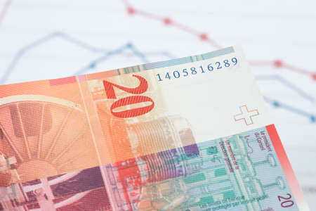 A chart and a Swiss franc banknoteの写真素材