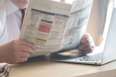 A man and a newspaper with job advertisementsの写真素材