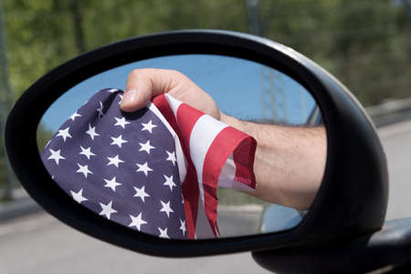 Flag of America visible in the mirror of a carの写真素材