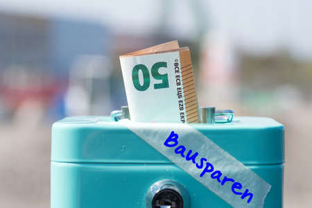 A money box, Euro bill and building savingsの写真素材