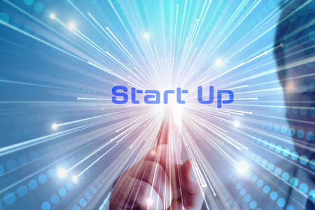 A man touches the word Start Up on a screenの写真素材