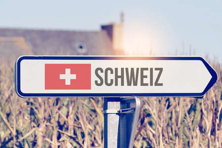 A sign points to Switzerlandの写真素材