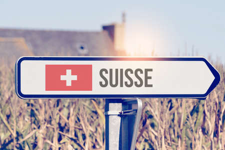 A sign points to the direction Switzerlandの写真素材