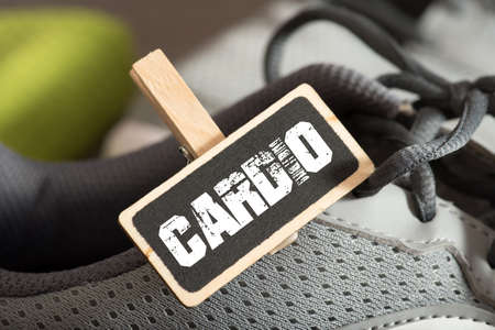 Running shoes and a sign with the word cardioの写真素材