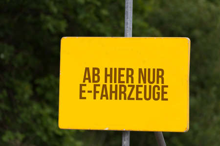 A sign points out the way for electric vehiclesの写真素材