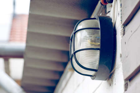 An old lamp on the outside of the facade