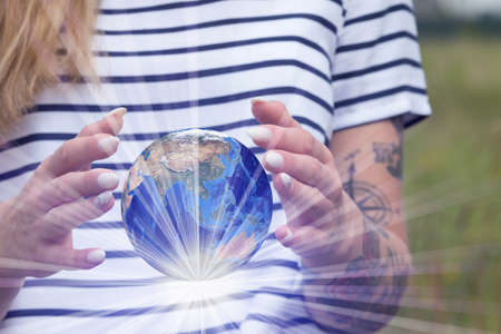 A woman and globe in her handsの写真素材